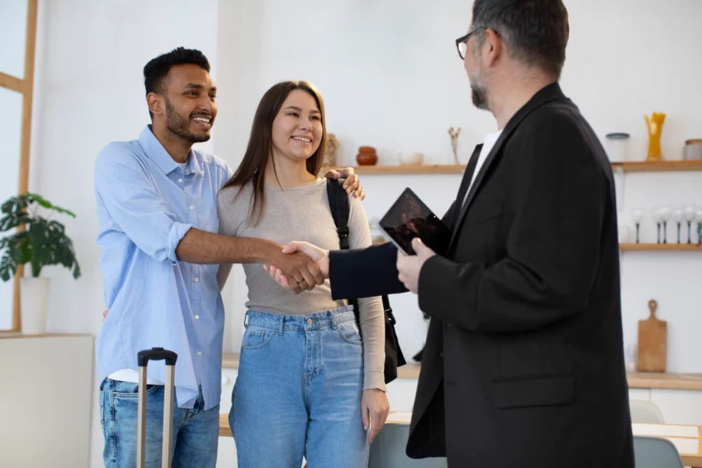 medium shot guest host shaking hands scaled